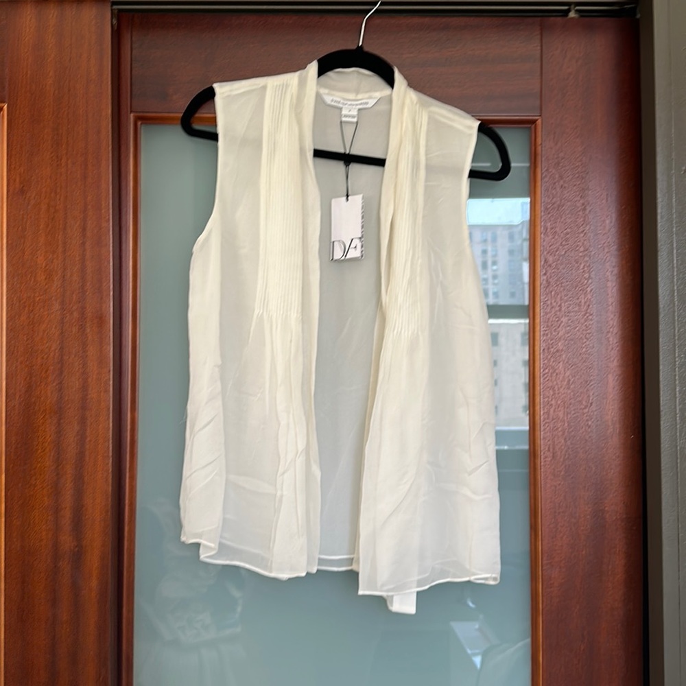 Cream sleeveless blouse